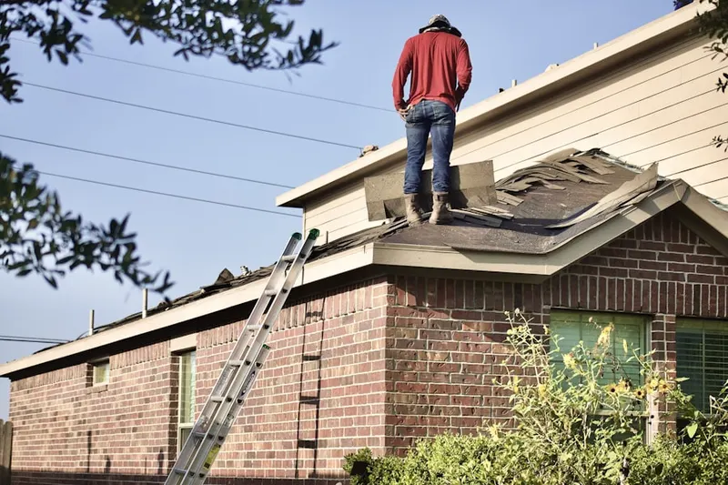 Professional roofer working on a residential roof in Carol Woods